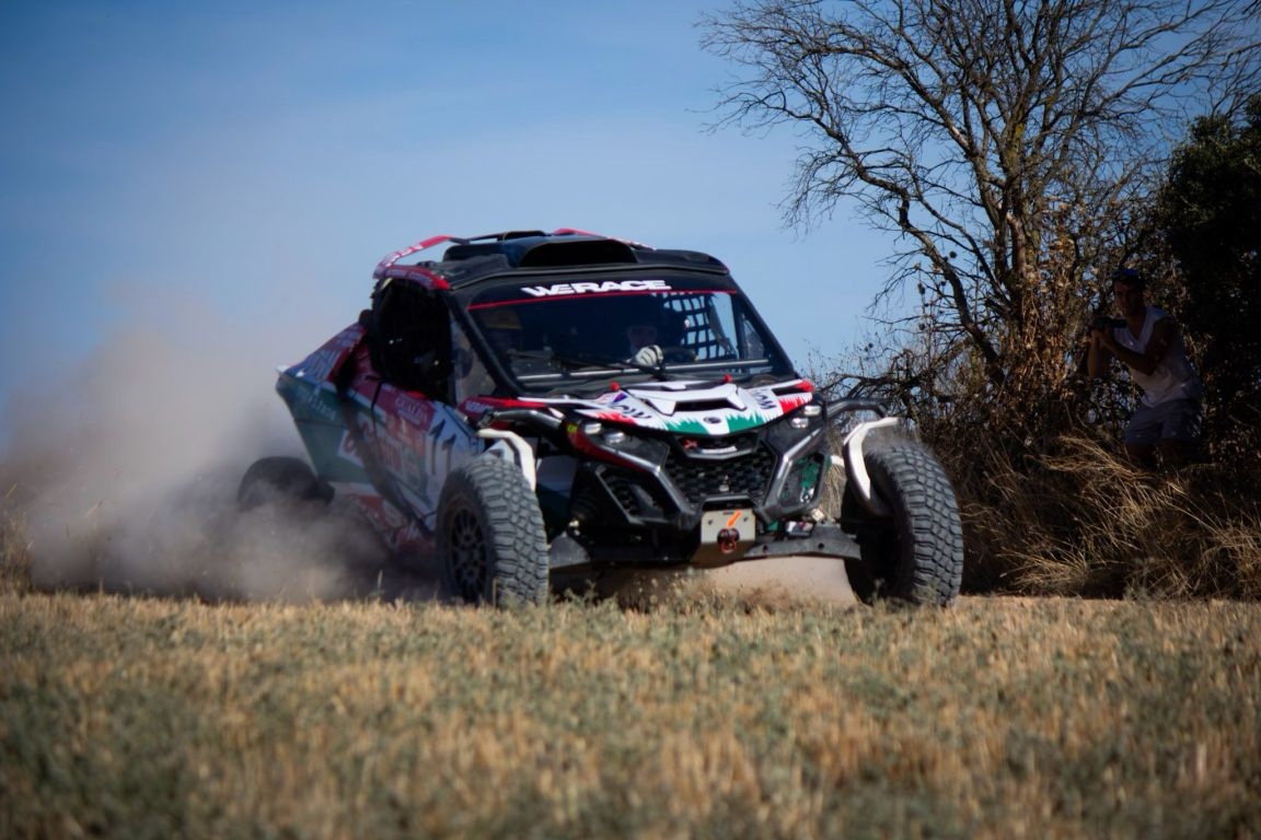 WERACE off-road racing car competing on a dirt course